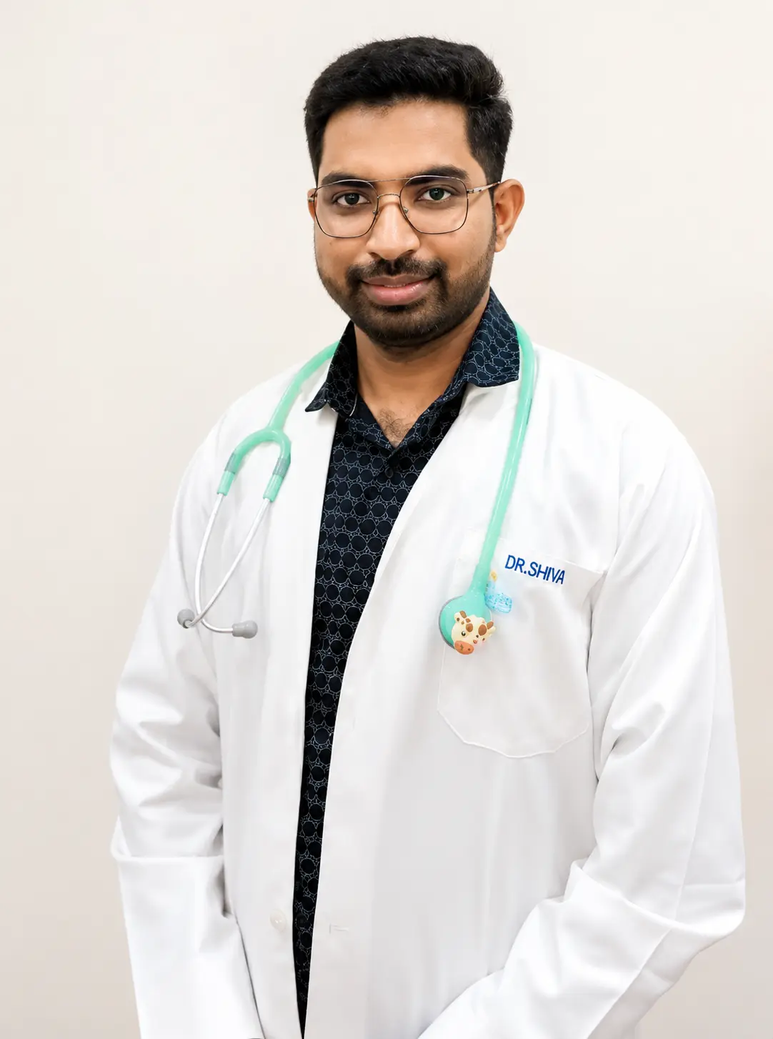 Professional headshot of a male doctor wearing a white coat and stethoscope, with glasses and a slight smile, against a clean light background in a circular crop.